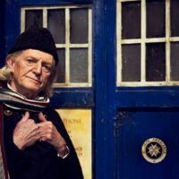 David Bradley as William Hartnell (the First Doctor) in front of the TARDIS