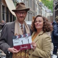 Mark Gatiss & Polly Walker on set, with a clapperboard for the first shot of Bookish